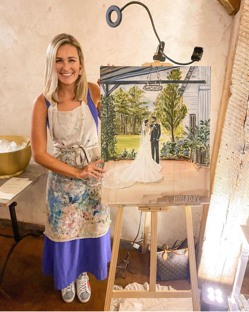 Rosilyn Holladay displaying her live wedding painting in Hattiesburg, Mississippi.
